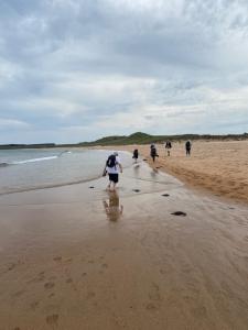 Walkers paddling in sea